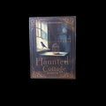 Haunted Cottage Oracle deck box featuring a bird on a windowsill with a golden birdcage